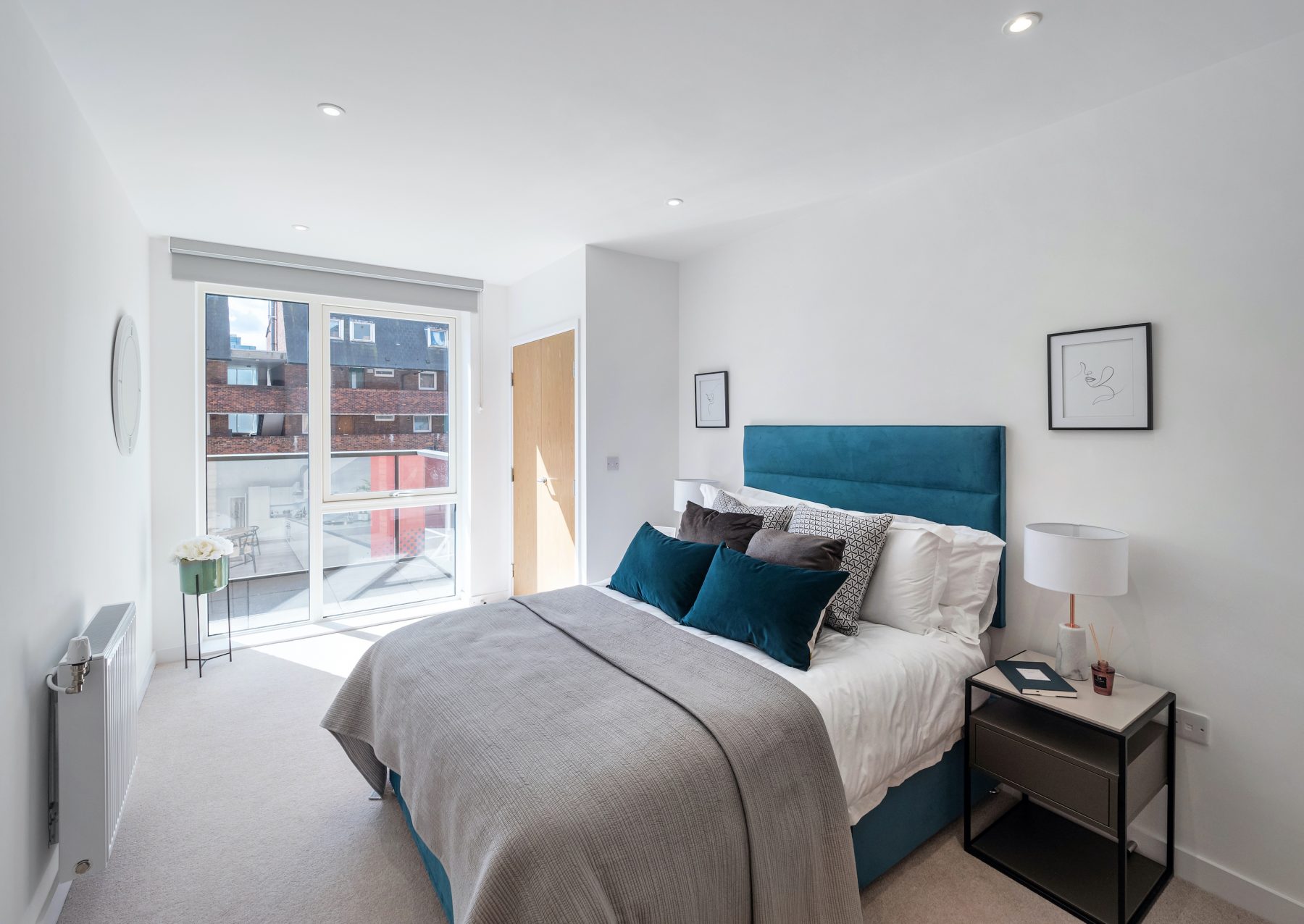 Smart stylish bedroom with blue headboard and cushions