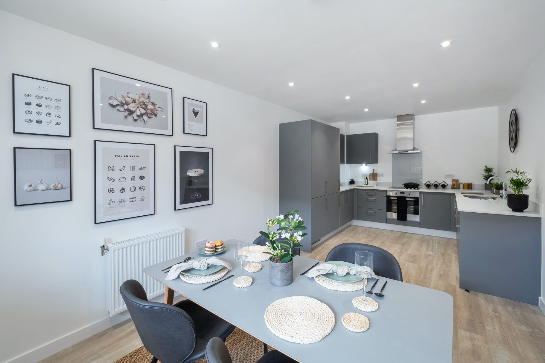 Smart sophisticated dining room and kitchen with artwork on walls